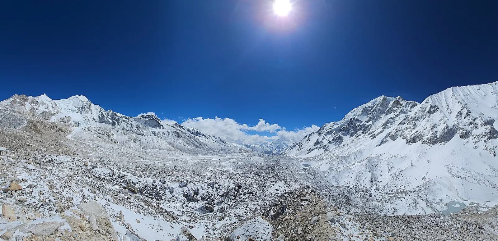 Trekkers crossing prayer-flag adorned Larkya La Pass at 5,106 metres on the Manaslu Circuit.